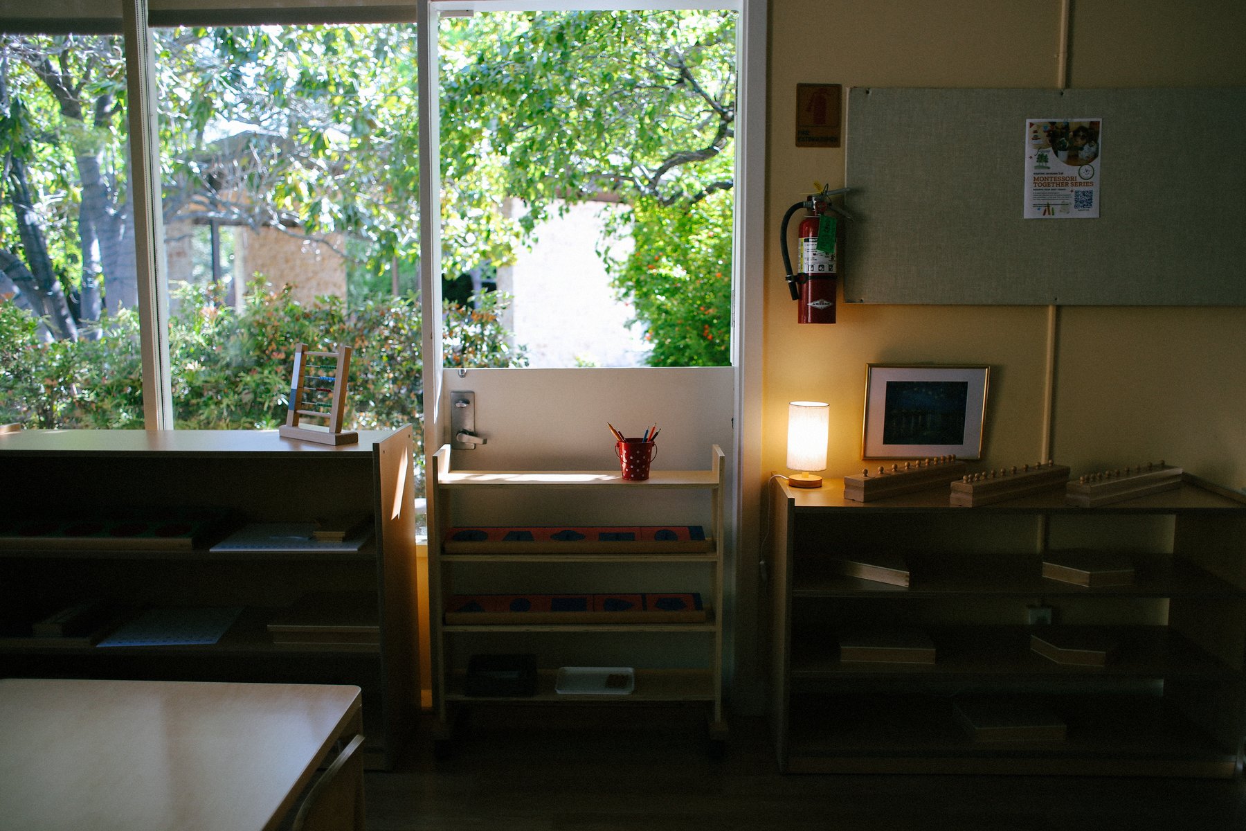 Montessori shelf near a window looking out to the garden