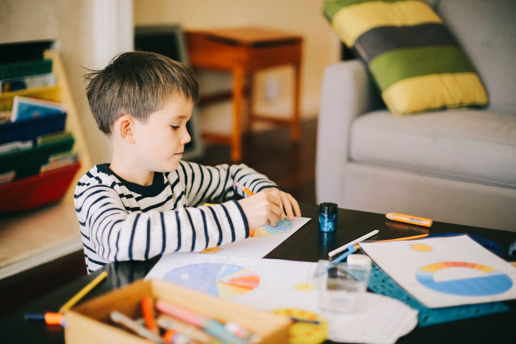 Student coloring circular geometry diagrams during Montessori classroom work